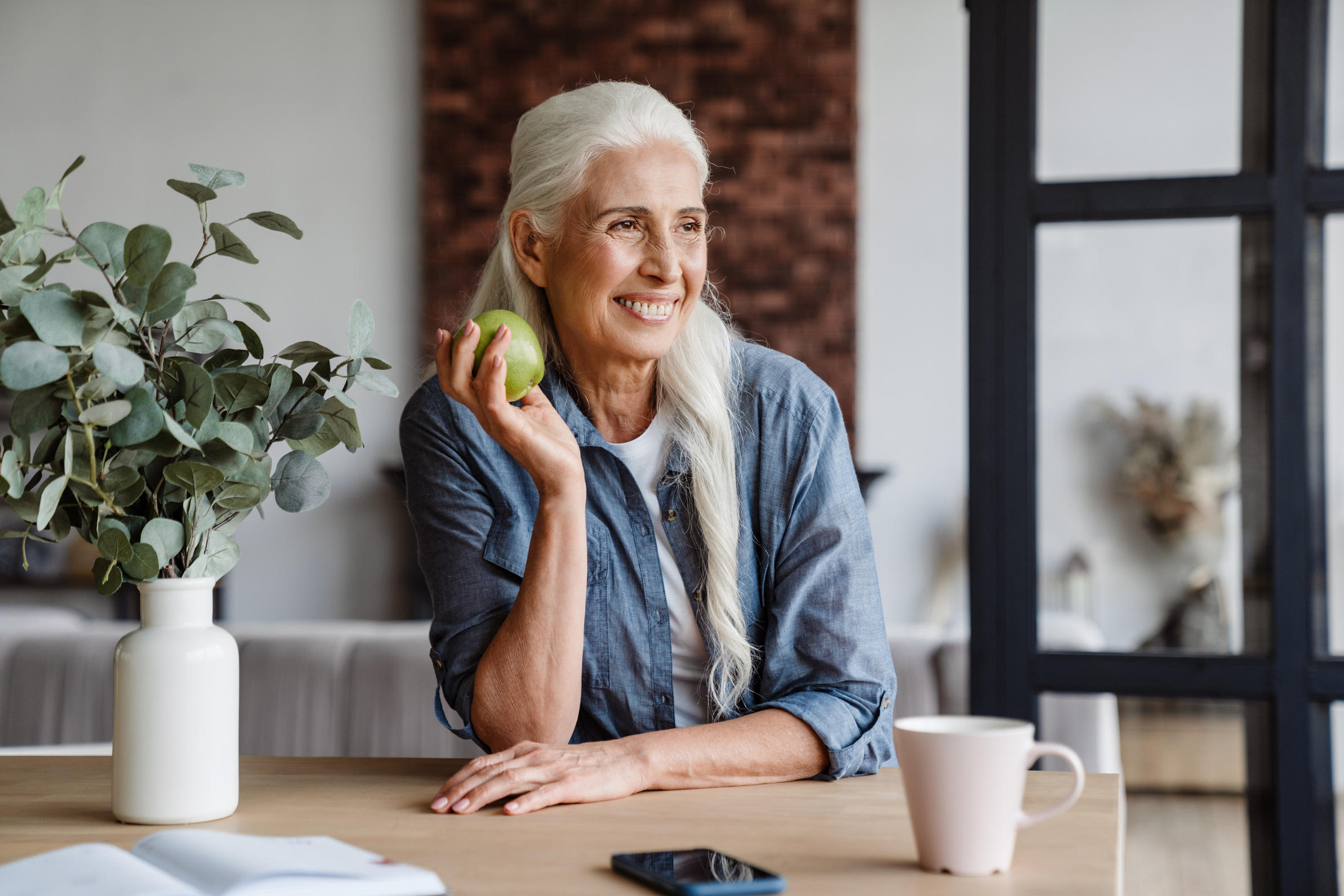 Happy Senior Woman Eating Healthy Green Apple